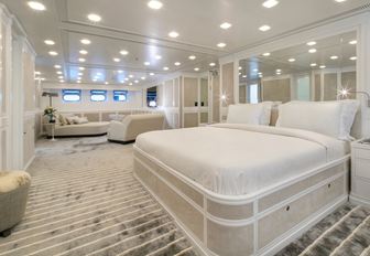 master suite with neutral colour palette and seating area on board luxury yacht Spirit of the C’s