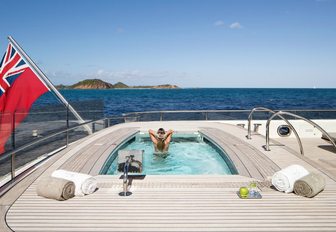 charter guest takes a refreshing dip in the aft deck pool