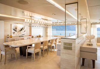 Superyacht DRAGON interior dining area and views onto the ocean beyond