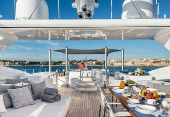 seating, dining table and Jacuzzi on board sundeck of luxury yacht Her Destiny