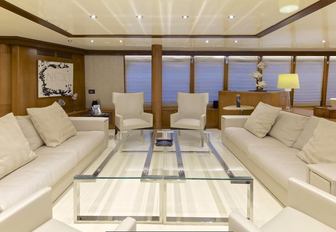 Thhe glass table and surrounding sofa seating on board motor yacht O'LEANNA