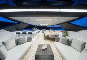 Fresh white sofas and a small table on board luxury yacht Seven Sins