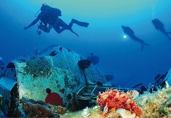 Scuba divers examine a shipwreck in Greece