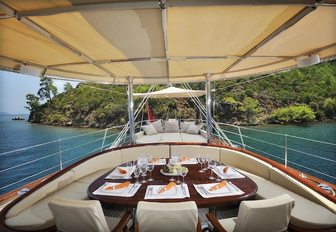 shaded aft deck dining area on board charter yacht Aria I 