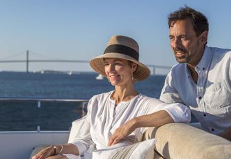 charter guests sit on the sundeck of superyacht Far From It 
