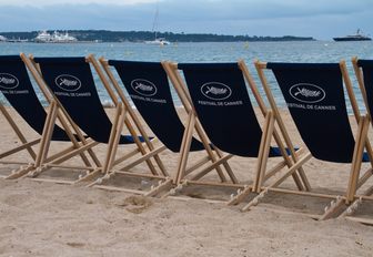 film festival deckchairs line a sandy beach in Cannes, France