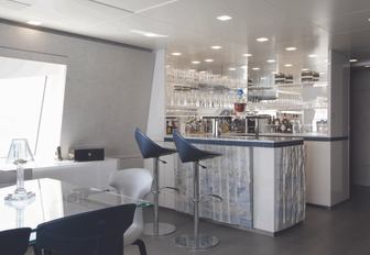 bar next to indoor dining table in skylounge aboard motor yacht ‘H