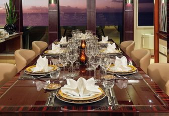 formal dining setup in the main salon of motor yacht Grey Matters