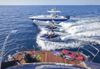 swim platform lined with water toys as well as tenders and jet skis in the water from luxury yacht ‘Big Change II’ 