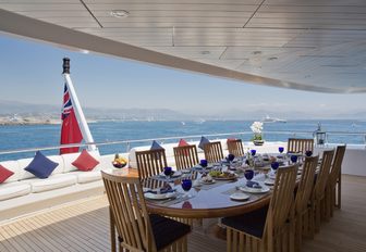 rectangular alfresco dining table on upper deck aft of charter yacht SARAH 