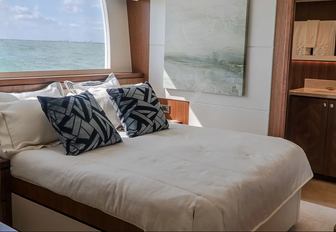 Double bed in stateroom with window behind on motor yacht ENTREPRENEUR