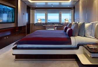 tranquil master suite with large TV opposite bed on board charter yacht ASYA 