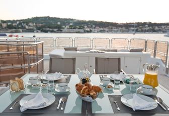 breakfast is served on the sundeck's alfresco dining table on board charter yacht ‘African Queen’ 
