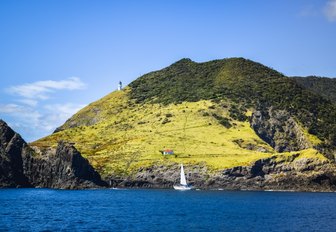 deserted house and sailing yacht in the Bay of Islands, New Zealand
