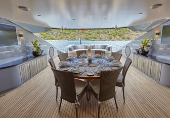 circular dining table on the main deck aft of luxury yacht Grey Matters