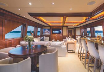 games table, bar and lounge area in the skylounge aboard luxury yacht Far From It 