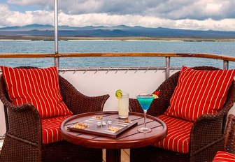 two arm chairs in the alfresco lounge on the upper deck aft of superyacht GRACE 
