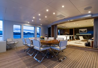 alfresco dining setup on the upper deck aft of luxury yacht GO
