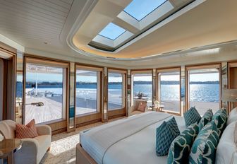 master suite with skylight and full-length windows on board luxury yacht Joy