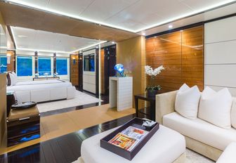 expansive master with bed and lounge area on board luxury yacht Party Girl
