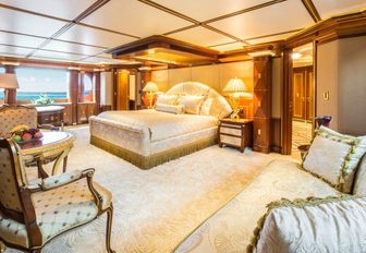 Large master suite with cream furnishings and large windows on superyacht my seanna
