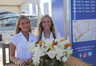 staff welcome visitors to Super Yachts Miami, part of the Miami yacht Show