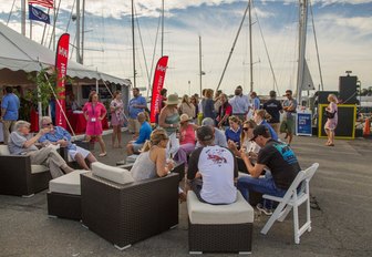 attendees at the Newport Charter Yacht Show gather at dusk for entertainment