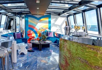 beautiful salon with colourful artworks on board charter yacht HIGHLANDER