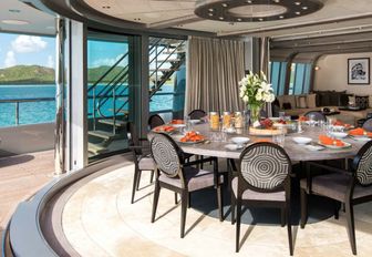 circular dining table on the upper deck of superyacht SLIPSTREAM