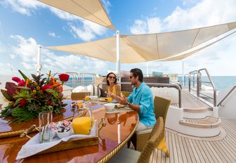 charter guests enjoy breakfast on the sundeck of charter yacht Lumiere II