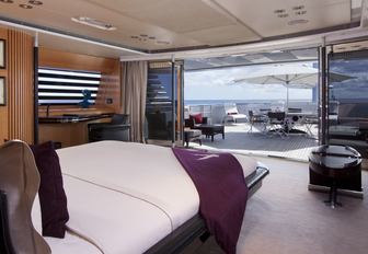 master suite with sliding doors onto a deck area on board luxury yacht Maltese Falcon