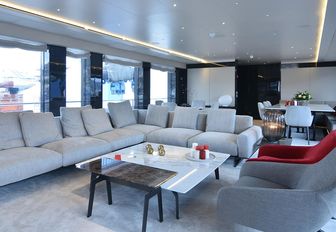 modern and inviting main salon with huge sofa on board charter yacht My Eden