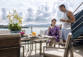 guests enjoy breakfast on the upper deck aft of charter yacht ‘Ocean Emerald’ 
