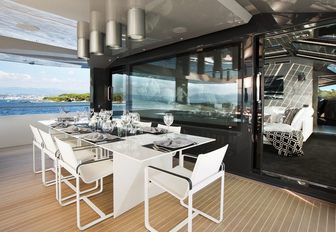 dining alfresco on the upper deck aft of luxury yacht JURATA 