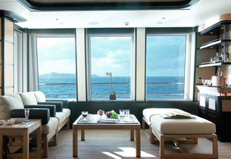 large windows flank seating area on the upper deck aft of luxury yacht HARLE 