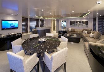 games table and long sofa in skylounge aboard motor yacht Hurricane Run’