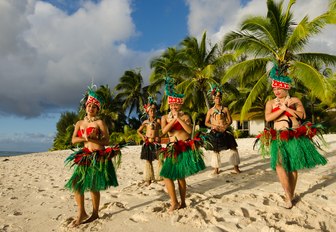 Tahitian dance group perform on a sandy beach in Tahiti, French Polynesia