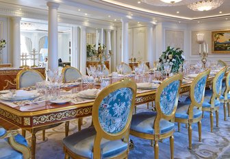 Dining salon with blue and white chairs on luxury yacht TIS