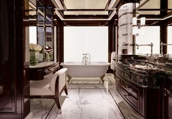 En suite bathroom on board luxury charter yacht RockIt, with marble bath and sink