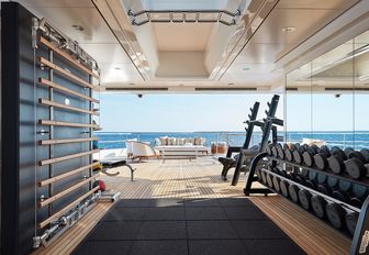 fully-equipped gym on the bridge deck of charter yacht JOY
