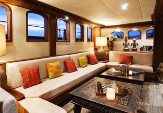 welcoming lounge with Balinese crafts in main salon of superyacht Mutiara Laut 