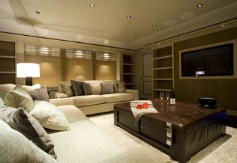 large sofas face a widescreen TV in the skylounge of motor yacht ODESSA 