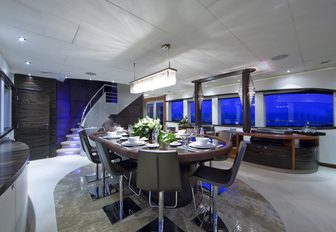 One Blue dining area at night, with crystal chandelier and glossy marble floors