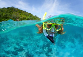 a snorkeller explores the marine life while on a luxury yacht charter in Thailand