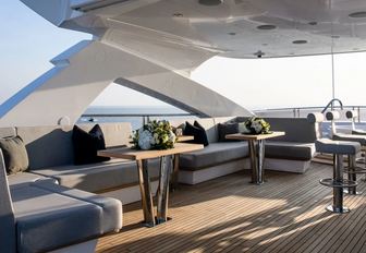 chic seating areas and bar stools on the sundeck of motor yacht Berco Voyager