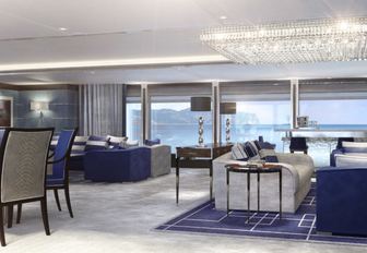 Interiors of luxury charter yacht North Star, with navy blue accents and plush grey furnishings