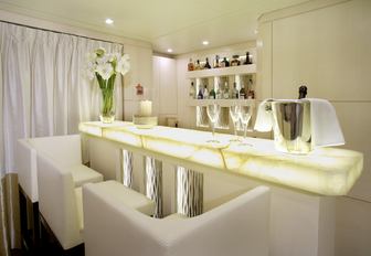 backlit onyx bar in main salon aboard luxury yacht ROMA