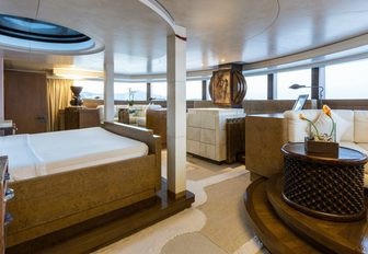 bed under skylight in the Polynesian-themed master suite aboard charter yacht Coral Ocean