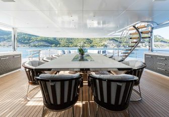 al fresco dining table on the upper deck aft of charter yacht RUYA 