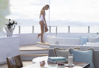 A charter guest entering the Jacuzzi on board superyacht TURQUOISE